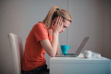 Young troubled woman using CRM at home