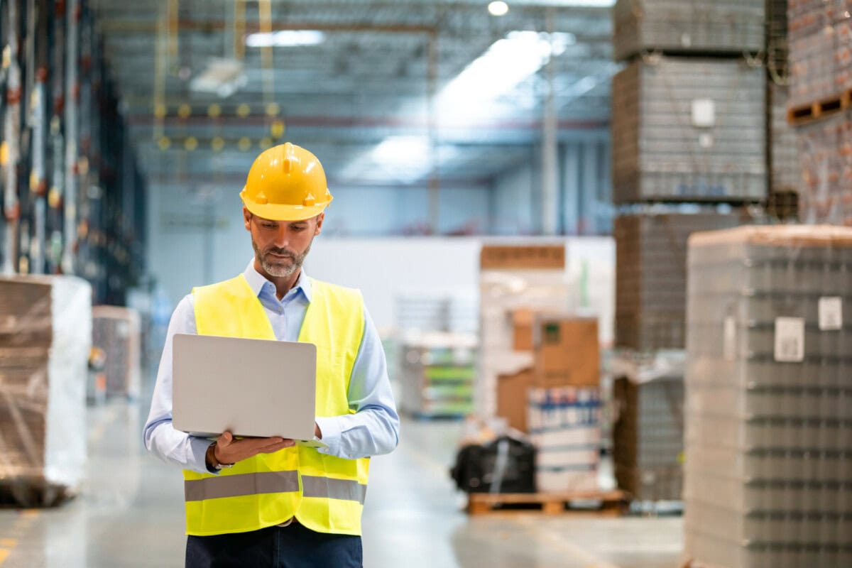 warehouse,manager,with,laptop,entering,inventory,data,to,database