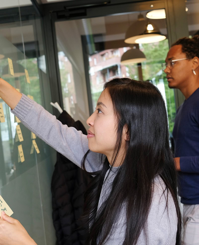 Girl organizing sticky notes on wall