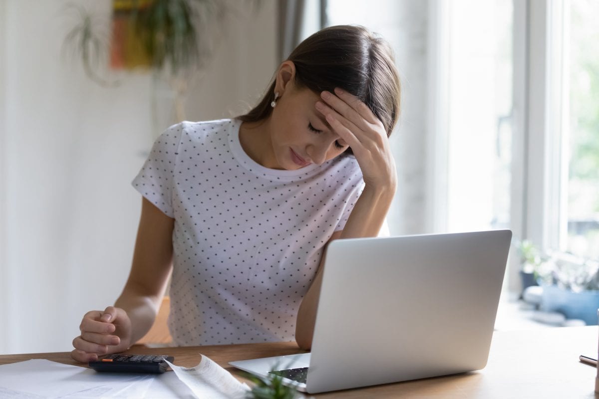 out,of,budget.,worried,young,woman,working,with,financial,papers